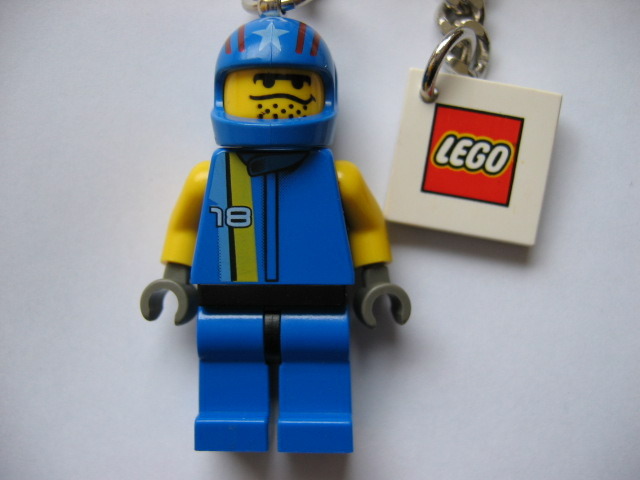 Drome Racer Key Chain with Closed Mouth and Stubble Head Key Chain with 2 x 2 Square Lego Logo Tile