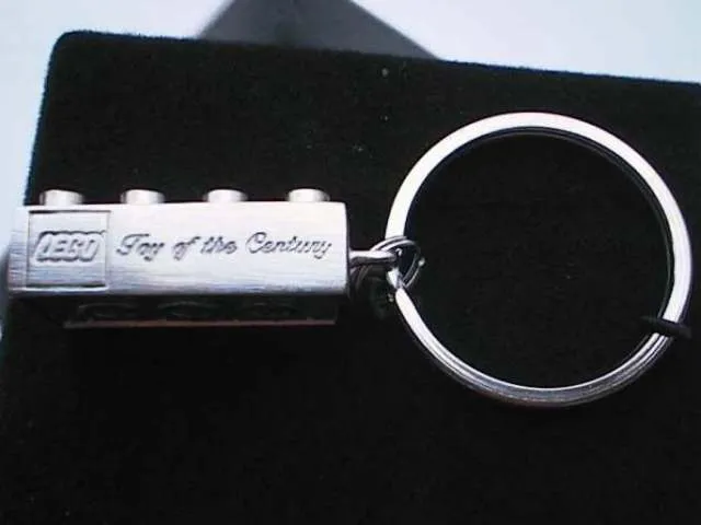 2 x 4 Brick - Chrome Silver Key Chain Debossed with LEGO Logo and Script 'Toy of the Century'