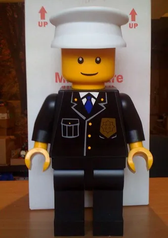 Display Figure 7in x 11in x 19in (black jacket, black pants, white hat, Police)