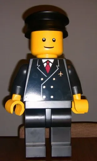 Display Figure 7in x 11in x 19in (black jacket, black pants, black hat, Airport)