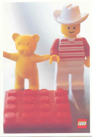 Postcard - Lego Art Project 2002 - 027 - Minifigure with Yellow Bear Behind Red Brick