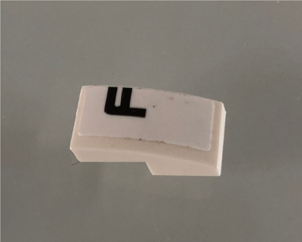 Slope, Curved 2 x 1 x 2/3 with Black Letter F on White Background Pattern Model Left Side (Sticker) - Set 42096