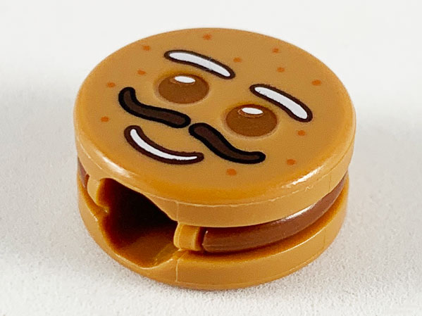 Minifigure, Head, Modified Cookie Shape with Reddish Brown Eyes and Frosting, White Eyebrows and Mouth, Dark Brown Moustache Pattern (Gingerbread Man)