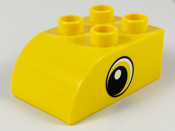 Duplo, Brick 2 x 3 Slope Curved with Circled Black Eye with Crescent and White Pupil Pattern on Both Sides