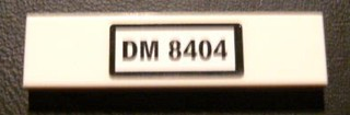 Tile 1 x 4 with Black 'DM 8404' on White Background Pattern (Sticker) - Set 8404