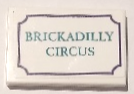 Tile 2 x 3 with Dark Turquoise 'BRICKADILLY CIRCUS' and Dark Purple Border Pattern Model Left Side (Sticker) - Set 41714