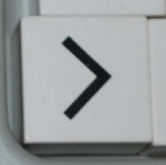 Duplo, Tile 2 x 2 x 1 with Black Less Than Sign (<) / Greater Than Sign (>) Pattern