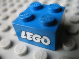 Brick 2 x 2 with Lego Logo Open O Style White with Black Outline Pattern