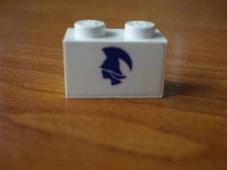 Brick 1 x 2 with Blue Britannia Logo Pattern Model Left Side (Sticker) - Set 1599