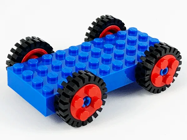 Brick, Modified 4 x 10 with 4 Pins with 4 Red Wheel FreeStyle with Technic Pin Hole and 4 Black Tire 24mm D. x 8mm Offset Tread - Interior Ridges (30076 / 6248 / 3483)