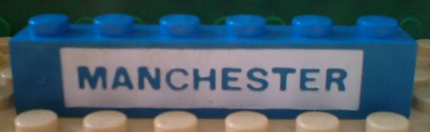 Brick 1 x 6 with Blue in White 'MANCHESTER' Pattern
