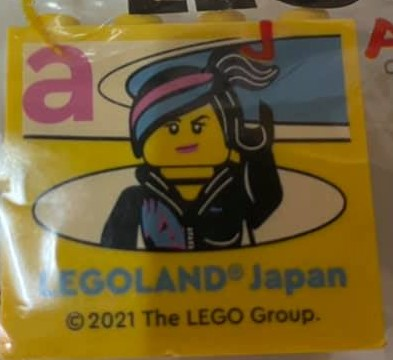 Brick 2 x 4 x 3 with LEGOLAND Japan, Wyldstyle Minifigure, and Dark Pink Lowercase Letter a Pattern