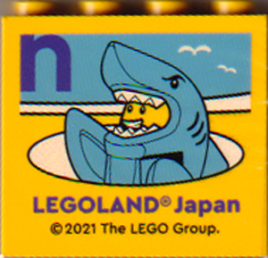 Brick 2 x 4 x 3 with LEGOLAND Japan, Shark Suit Guy Minifigure, and Dark Purple Lowercase Letter n Pattern