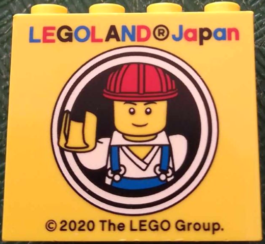 Brick 2 x 4 x 3 with LEGOLAND Japan and Male Construction Worker Minifigure with Red Helmet in White Circles Pattern