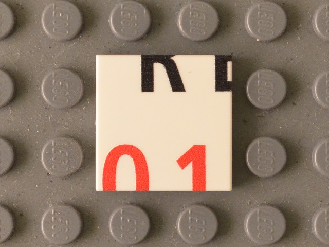 Tile 2 x 2 with Black 'RE' Lower Half and Red '01' Upper Half Pattern