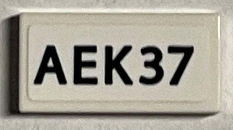 Tile 1 x 2 with Black 'AEK37' Pattern (Sticker) - Set 21330