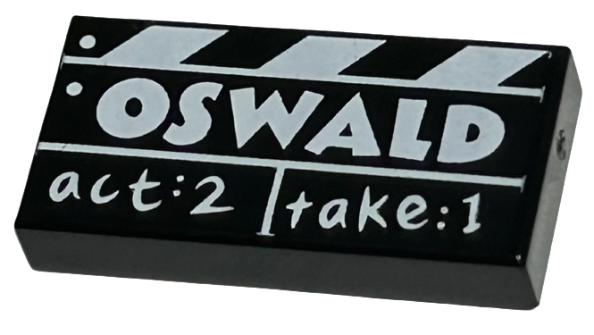 Tile 1 x 2 with Film Slate with White 'OSWALD' and 'act:2 take:1' Pattern
