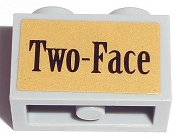 Technic, Brick 1 x 2 with Axle Hole with Black 'Two-Face' on Gold Background Pattern (Sticker) - Set 7785