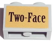 Technic, Brick 1 x 2 with Axle Hole with Black 'Two-Face' on Gold Background Pattern (Sticker) - Set 7785