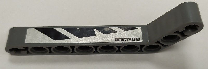 Technic, Liftarm, Modified Bent Thick 1 x 9 (7 - 3) with Black 'ReakT-V8' and Polygons on Silver Background Pattern Model Right Side (Sticker) - Set 8863