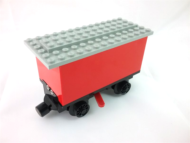 Train Battery Box Car with Three Contact Holes, Red Switch Lever, Black Magnets, Black Wheels, and Light Gray Roof