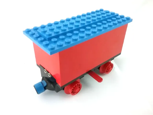 Train Battery Box Car with Two Contact Holes, Red Switch Lever, Blue and Red Magnets, Red Wheels, and Blue Roof