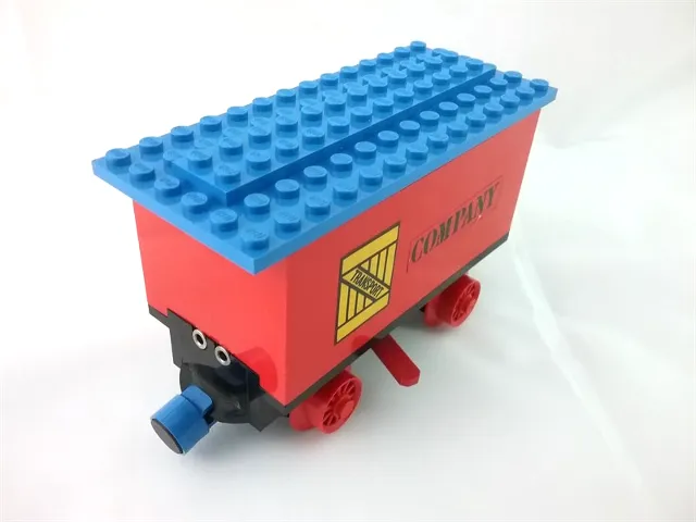 Train Battery Box Car with Two Contact Holes, Red Switch Lever, Blue and Red Magnets, Red Wheels, and Blue Roof with 'TRANSPORT' on Yellow Box and 'COMPANY' Pattern on Both Sides (Stickers) - Set 180