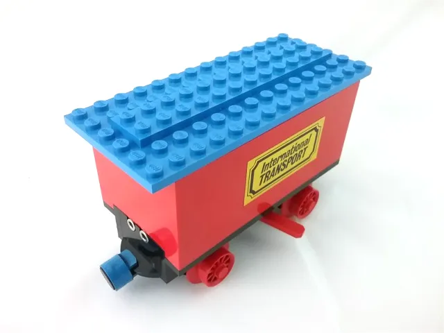 Train Battery Box Car with Two Contact Holes, Red Switch Lever, Blue and Red Magnets, Red Wheels, and Blue Roof with 'International TRANSPORT' Pattern on Both Sides (Stickers) - Sets 161 / 181-1 / 183