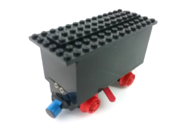 Train Battery Box Car with Two Contact Holes, Red Switch Lever, Blue and Red Magnets, Red Wheels, and Black Roof