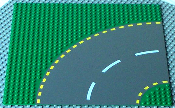 Baseplate, Road 32 x 32 6-Stud Curve with Dark Gray Road with Yellow Dashed Lines Pattern