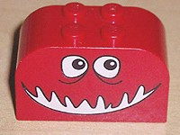Slope, Curved 4 x 2 x 2 Double with 4 Studs with Monster Face with Black and White Eyes, Open Mouth Smile Pattern