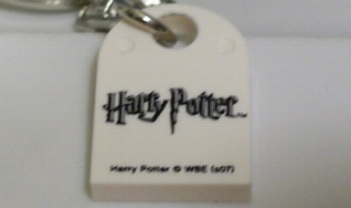 Tile, Modified 3 x 2 with Hole with Harry Potter Logo and 'Harry Potter © WBE (s07)' Pattern