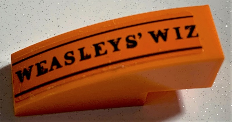 Slope, Curved 3 x 1 with Black 'WEASLEYS' WIZ' and Lines Pattern (Sticker) - Set 75978