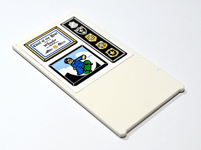 Glass for Window 1 x 4 x 6 with 'Chief of the Year Wheeler' Certificate in Frame, Gold Police Badges and Minifigure on Green Skateboard Pattern (Sticker) - Set 60246