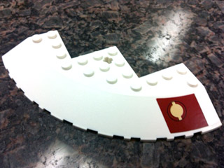 Brick, Round Corner 10 x 10 with Slope 33 Edge, Axle Hole, Facet Cutout with Jedi Logo on Dark Red Pattern Model Right (Sticker) - Set 9526