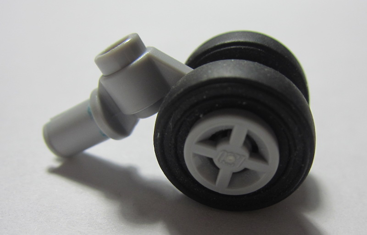 Technic Pin with Dual Wheels Holder with Light Bluish Gray Wheels and Black Tires (61483 / 4624 / 3139)