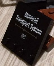 Tile, Modified 4 x 4 with Studs on Edge with 'Monorail Transport System 1987' Pattern