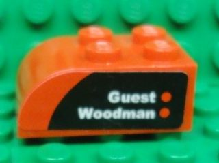 Slope, Curved 3 x 2 with 4 Studs with 'Guest' and 'Woodman' on Black and Red Background Pattern Model Right Side (Sticker) - Set 8655