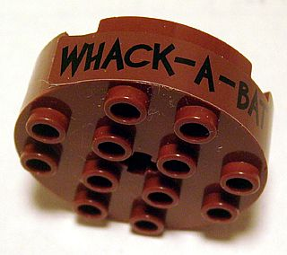 Brick, Round 4 x 4 with 4 Side Pin Holes and Center Axle Hole with 'WHACK - A - BAT' Pattern (Sticker) - Set 7886
