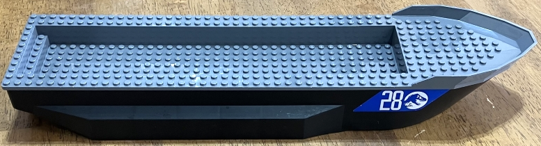 Boat, Hull Unitary 51 x 12 x 6 with Side Bulges with Dark Bluish Gray Top with Silver '28' and Jurassic World Logo on Blue Background Pattern on Both Sides and Back (Stickers) - Set 76942