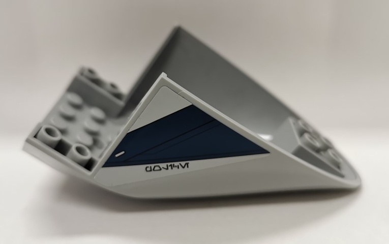 Aircraft Fuselage Aft Section Curved Bottom 6 x 10 with Dark Blue Trapezoid and Aurebesh Characters 'POLICE' on Light Bluish Gray Background Pattern on Both Sides (Stickers) - Set 75046