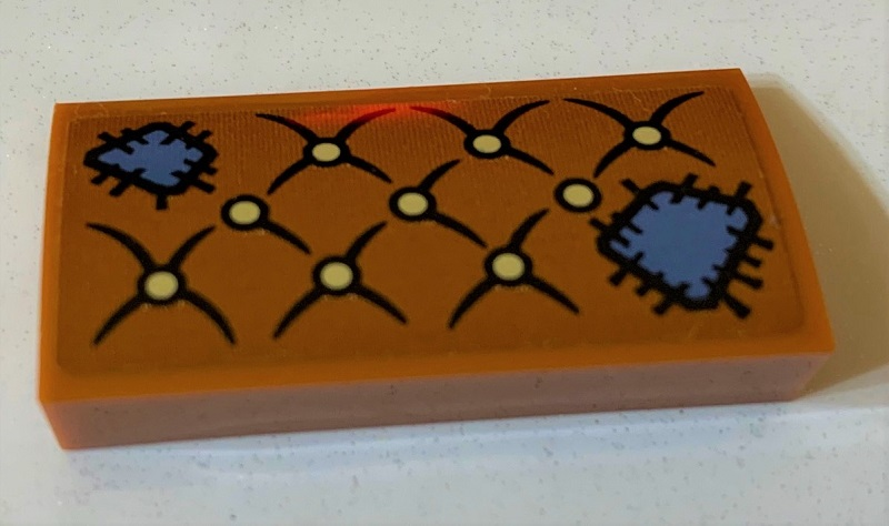 Slope, Curved 2 x 4 x 2/3 with Bottom Tubes with Cushion with Sand Blue Patches and Tan Buttons Pattern (Sticker) - Set 75978