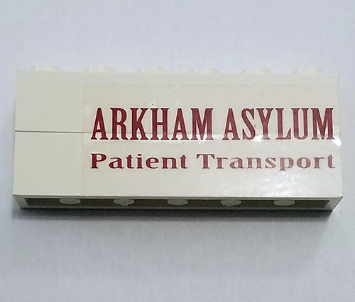 Stickered Assembly 6 x 1 x 2 with 'ARKHAM ASYLUM Patient Transport' Pattern Model Left Side (Sticker) - Set 7785 - 2 Brick 1 x 6