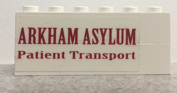 Stickered Assembly 6 x 1 x 2 with 'ARKHAM ASYLUM Patient Transport' Pattern Model Right Side (Sticker) - Set 7785 - 2 Brick 1 x 6