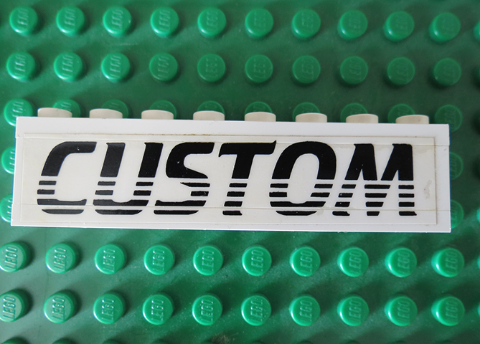 Stickered Assembly 8 x 1 x 1 2/3 with Black 'CUSTOM' Pattern (Sticker) - Set 5550 - 1 Brick 1 x 8, 2 Plate 1 x 8