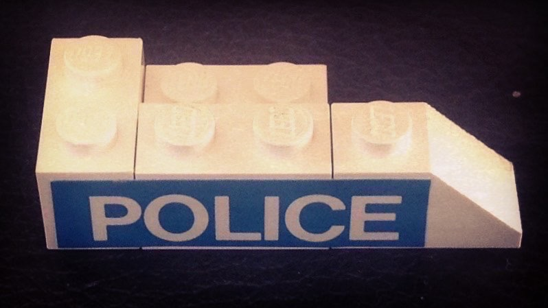 Stickered Assembly 5 x 2 x 1 with 'POLICE' Pattern Model Left Side (Sticker) - Set 394 - 1 Brick 1 x 2, 2 Plate 2 x 2, 1 Plate 1 x 2, 1 Slope 2 x 1