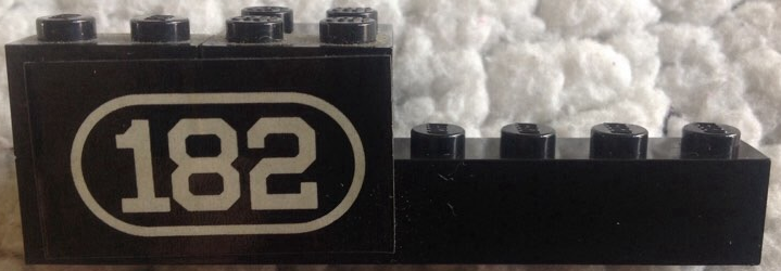 Stickered Assembly 8 x 2 x 2 with White Number 182 with Border on Black Background Pattern Model Left Side (Sticker) - Set 182 - 1 Brick 1 x 2, 1 Brick 1 x 8, 1 Brick 2 x 2