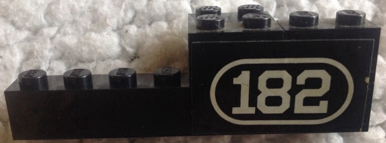 Stickered Assembly 8 x 2 x 2 with White Number 182 with Border on Black Background Pattern Model Right Side (Sticker) - Set 182 - 1 Brick 1 x 2, 1 Brick 1 x 8, 1 Brick 2 x 2