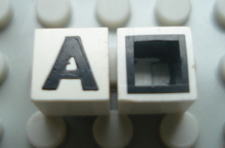 Modulex, Tile 1 x 1 with Black 'A' Pattern (with black lining on sides only)