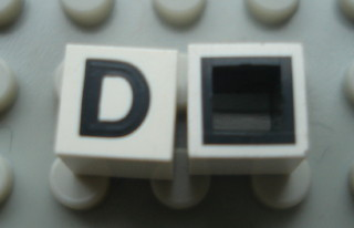 Modulex, Tile 1 x 1 with Black 'D' Pattern (with black lining on sides only)